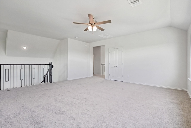 additional living space with ceiling fan, lofted ceiling, and light carpet