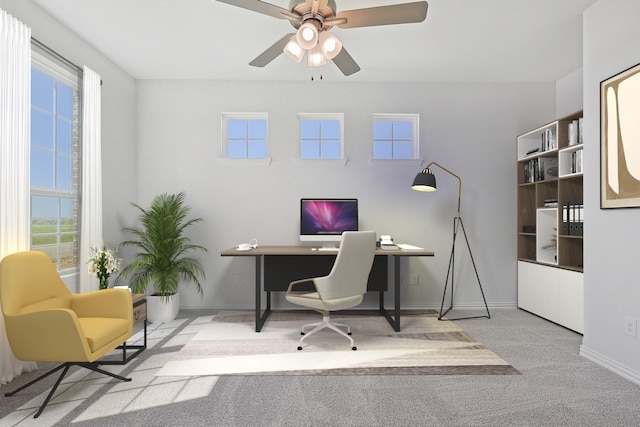 carpeted home office featuring a wealth of natural light and ceiling fan