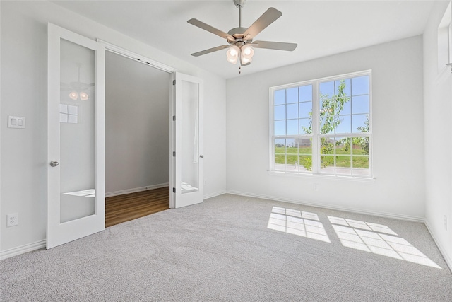 unfurnished bedroom featuring carpet flooring, ceiling fan, and french doors