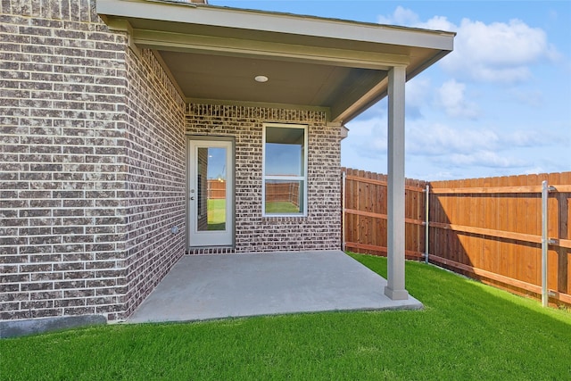 property entrance featuring a yard and a patio area