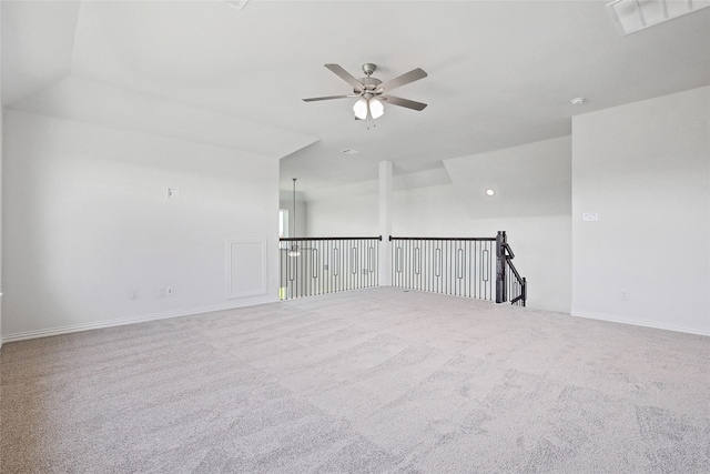 carpeted spare room with lofted ceiling and ceiling fan