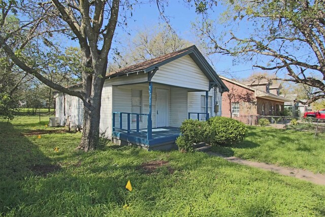 exterior space featuring central AC and a lawn