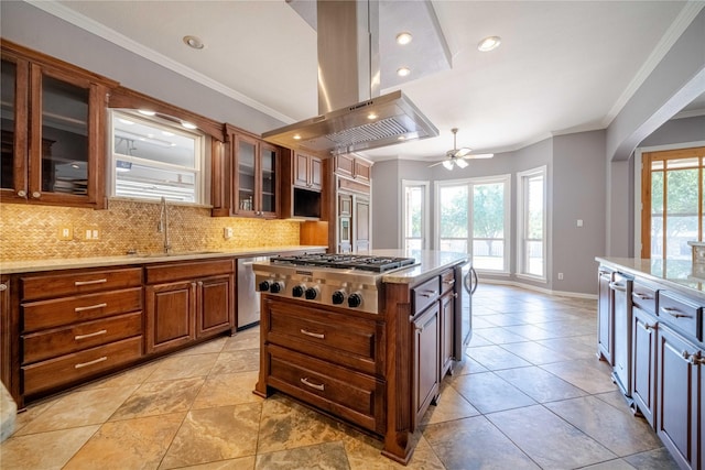 kitchen featuring sink, tasteful backsplash, island range hood, a kitchen island, and stainless steel appliances