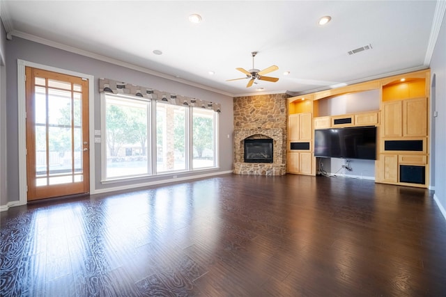 unfurnished living room featuring ornamental molding, a stone fireplace, dark wood-type flooring, and ceiling fan