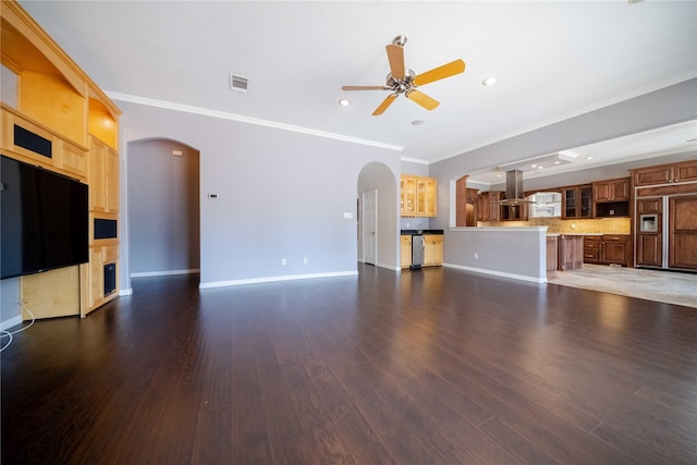 unfurnished living room with dark wood-type flooring, ceiling fan, and ornamental molding