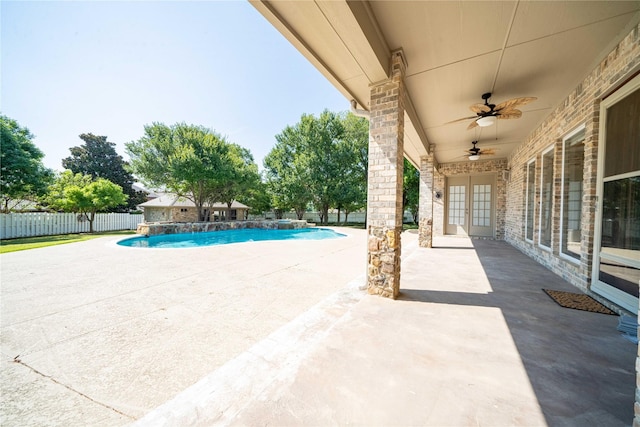 view of pool with french doors, ceiling fan, and a patio area