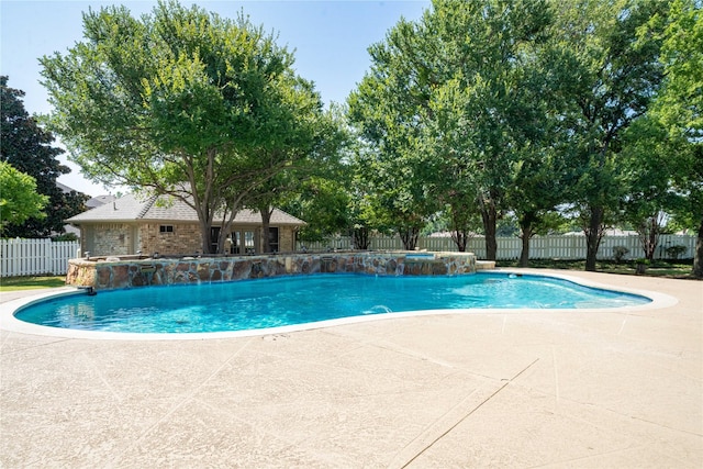 view of swimming pool with pool water feature and a patio