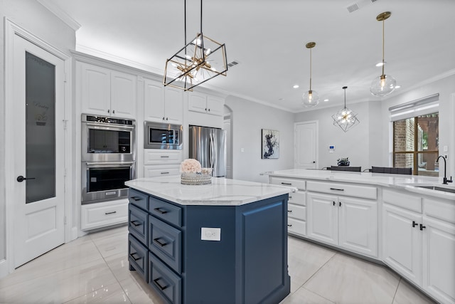 kitchen with a kitchen island, crown molding, white cabinets, pendant lighting, and appliances with stainless steel finishes