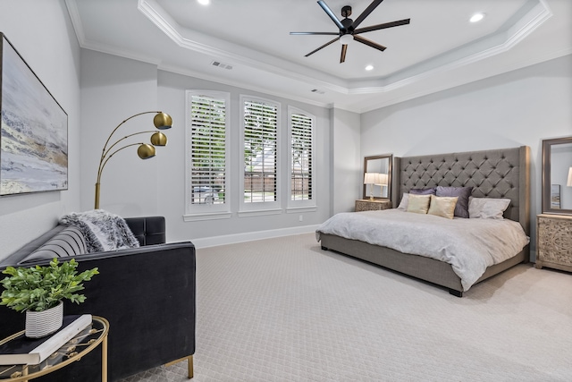 carpeted bedroom featuring ceiling fan, a raised ceiling, and crown molding