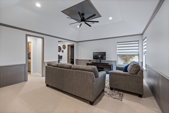 carpeted living room with crown molding and ceiling fan