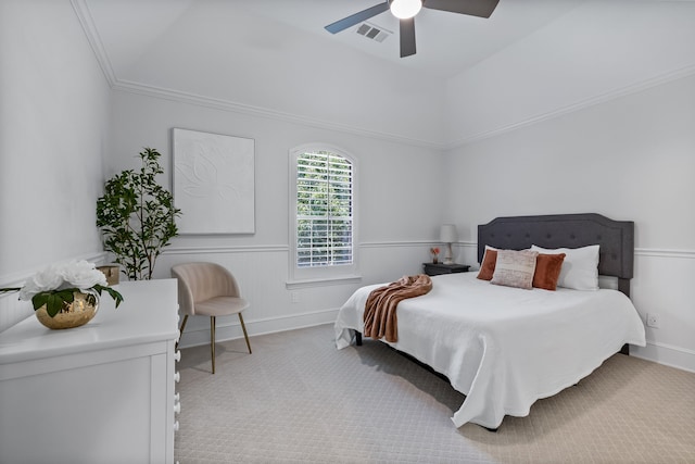 bedroom featuring crown molding, a raised ceiling, light carpet, and ceiling fan