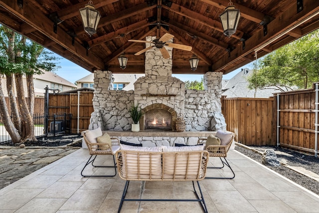 view of patio featuring a gazebo, an outdoor living space with a fireplace, and ceiling fan