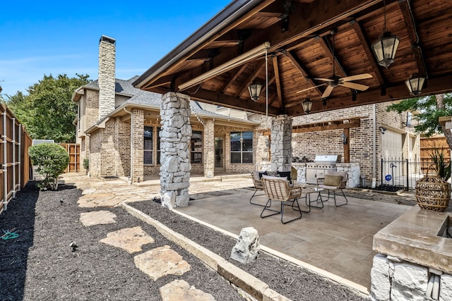 view of patio / terrace with area for grilling, an outdoor kitchen, and ceiling fan