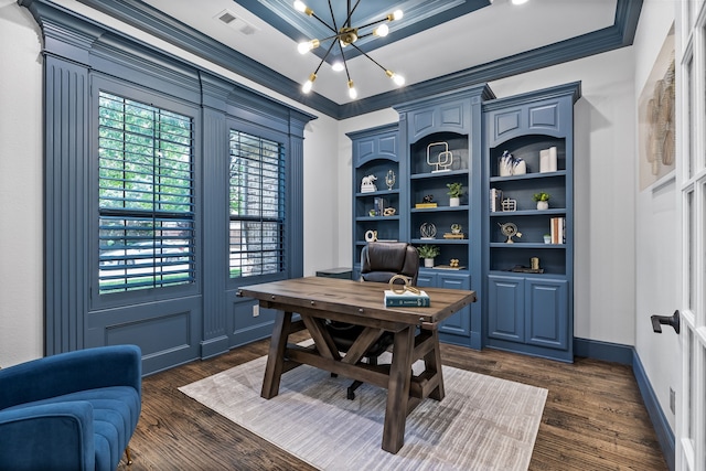 home office with a notable chandelier, ornamental molding, a tray ceiling, and dark wood-type flooring