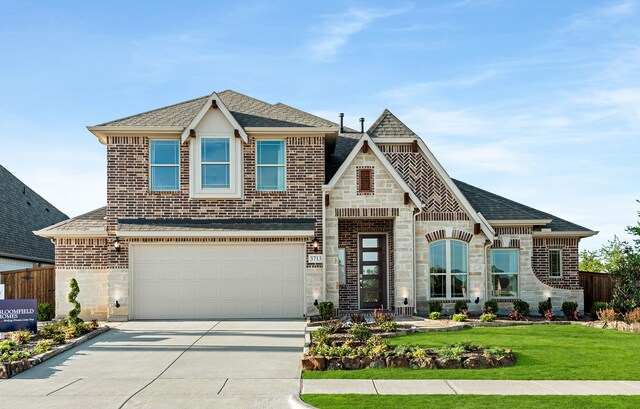 view of front of home featuring a garage and a front lawn