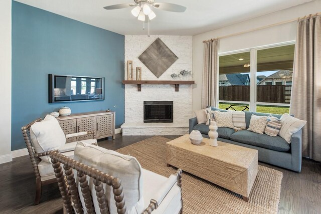 living room with hardwood / wood-style floors, a fireplace, and ceiling fan