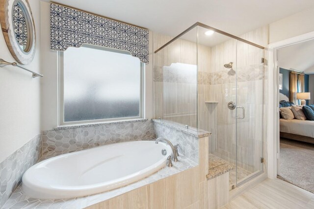 bathroom with separate shower and tub