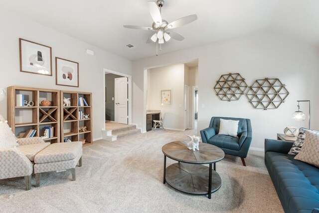 living room with lofted ceiling, carpet floors, and ceiling fan