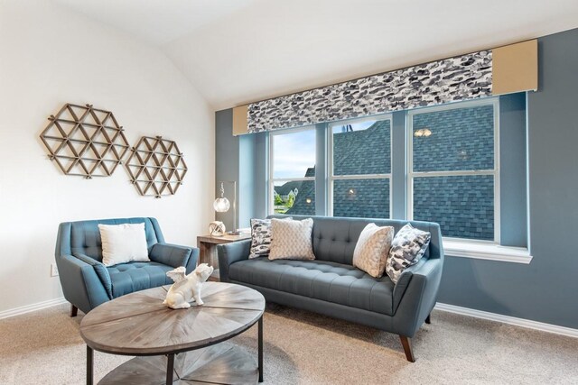 carpeted living room featuring lofted ceiling