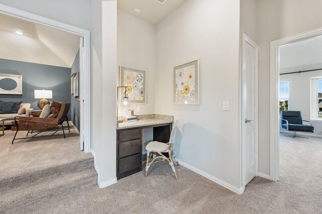 office space featuring light carpet and high vaulted ceiling