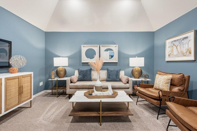 carpeted living room with lofted ceiling