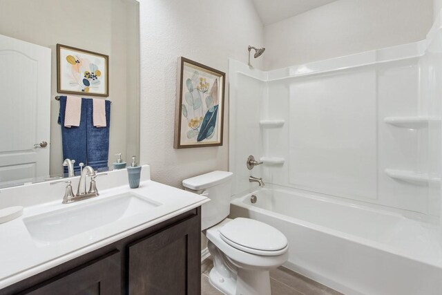 full bathroom featuring vanity, shower / tub combination, and toilet