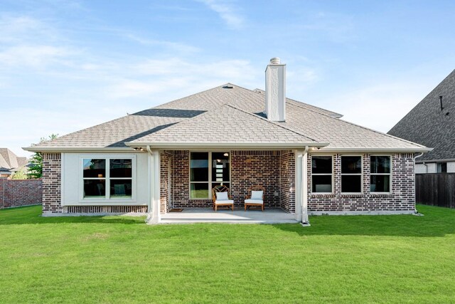 back of property featuring a yard and a patio