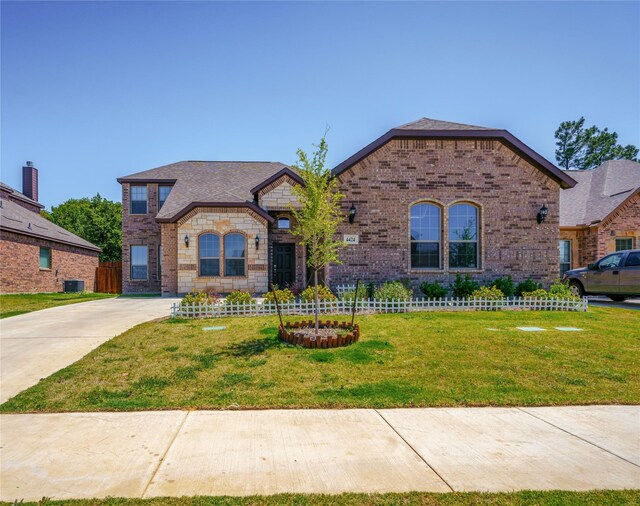 view of front facade with central AC and a front lawn