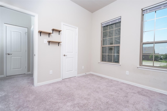 spare room featuring light carpet