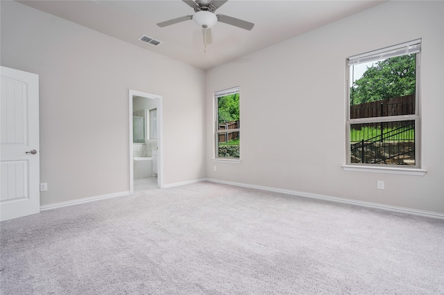 carpeted empty room with a healthy amount of sunlight and ceiling fan