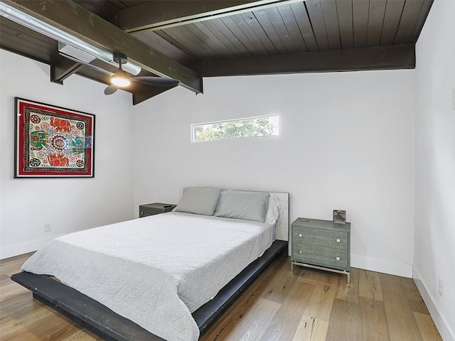 bedroom with vaulted ceiling with beams, hardwood / wood-style flooring, wooden ceiling, and ceiling fan