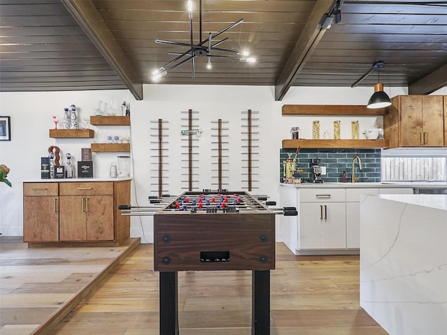 playroom featuring sink, wooden ceiling, beam ceiling, and light hardwood / wood-style flooring