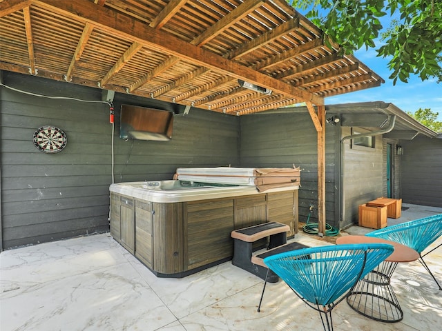 view of patio / terrace with a pergola and a hot tub