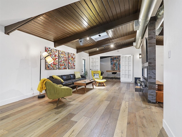 living room featuring vaulted ceiling with beams, wood ceiling, and light hardwood / wood-style flooring