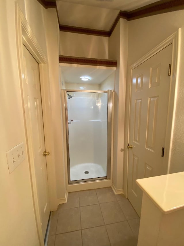 full bathroom featuring a stall shower and tile patterned floors