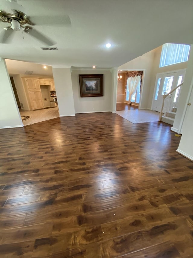 unfurnished living room featuring a ceiling fan, dark wood finished floors, baseboards, visible vents, and recessed lighting