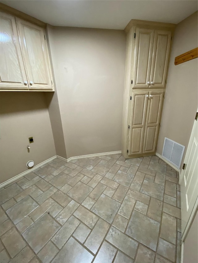 washroom with baseboards, cabinet space, visible vents, and hookup for an electric dryer