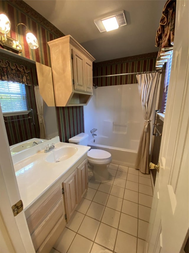 full bathroom with tile patterned flooring, vanity, shower / tub combo with curtain, toilet, and wallpapered walls