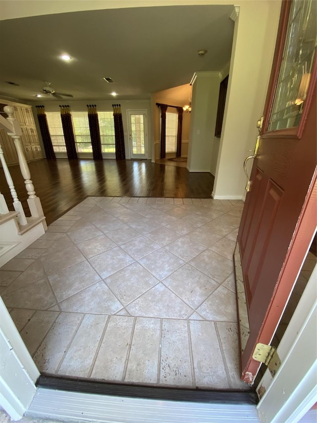 foyer featuring light tile patterned flooring and baseboards