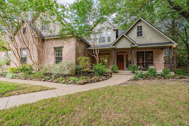 view of front of property with a front yard and a porch