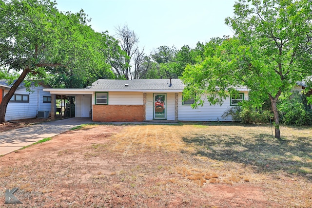 single story home with central AC and a carport