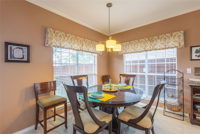 dining area with a notable chandelier, crown molding, and light tile patterned flooring