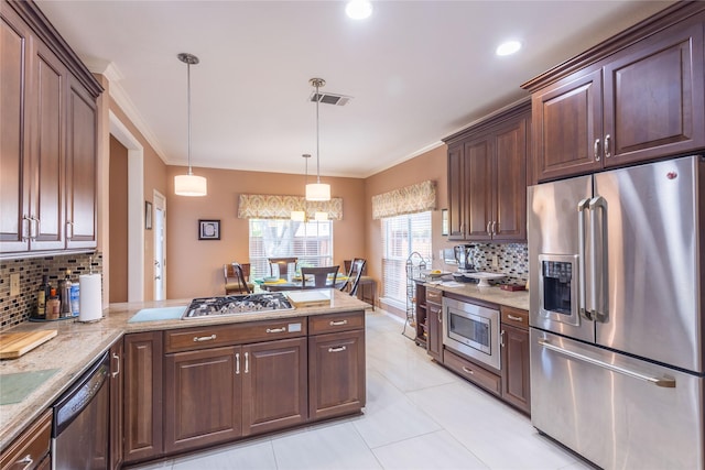 kitchen featuring ornamental molding, appliances with stainless steel finishes, pendant lighting, and backsplash