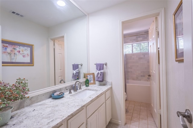 full bathroom with tiled shower / bath combo, vanity, tile patterned flooring, and toilet