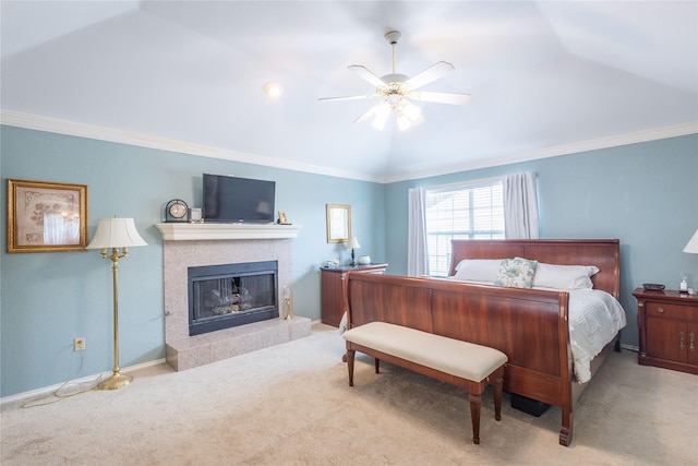 bedroom featuring vaulted ceiling, a fireplace, ornamental molding, ceiling fan, and light carpet