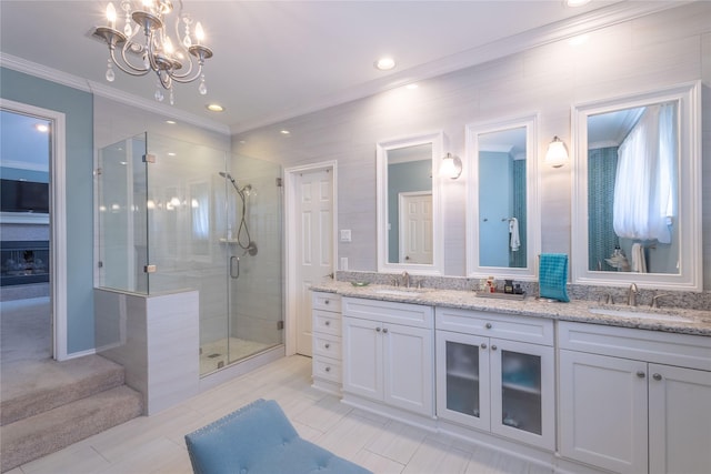 bathroom featuring a shower with door, vanity, and an inviting chandelier