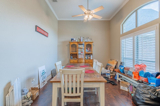 dining area featuring ceiling fan, crown molding, and dark hardwood / wood-style flooring