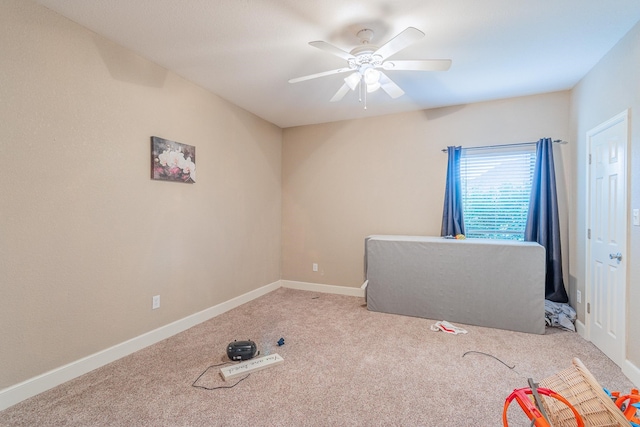 interior space with light carpet and ceiling fan