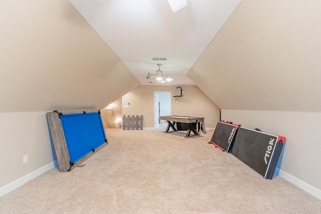 game room featuring vaulted ceiling and light colored carpet