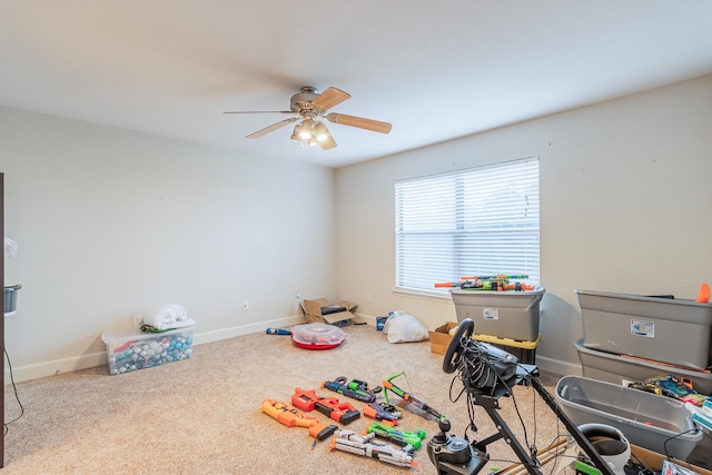 recreation room featuring carpet and ceiling fan